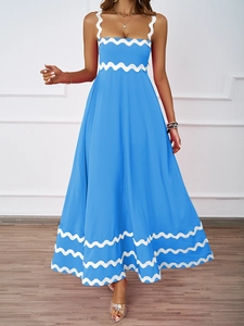 Detail of blue maxi dress with white scallop trim on neckline, waist, and hemline