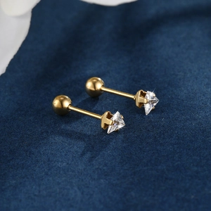 Macro view of gold triangle CZ stud earrings with secure screw back ball closure