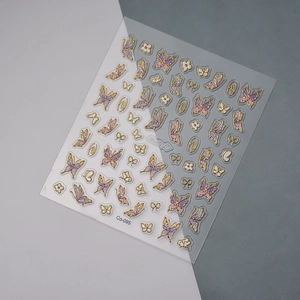 Detailed view of 5D butterfly nail decals with gold embossed edges and purple flowers