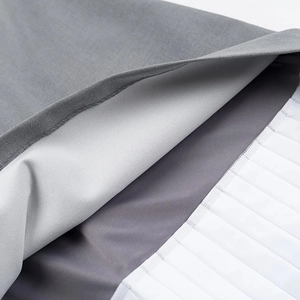 Detailed close-up of dark grey woven fabric stitched with white pleated accordion material