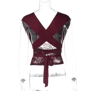 Detail view of burgundy lace halter top with criss-cross back straps and open back design