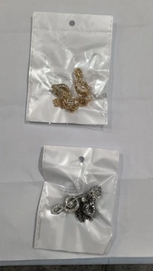 Detailed view of silver and gold musical note brooches with sparkling crystal inlay