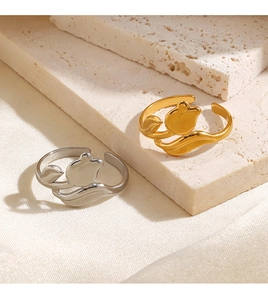 Macro view of gold and silver tulip-shaped open rings with adjustable metal bands