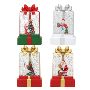 Set of four Christmas gift box snow globes featuring Santa Claus and snowman figurines