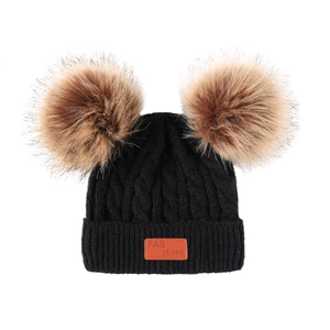 Black knit baby winter hat with double brown faux fur pom poms and leather patch