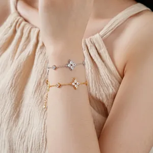 Exquisite gold and silver floral charm bracelets with zircons on a female model wrist
