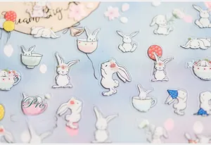Macro detail of 5D embossed rabbit nail stickers with floral patterns on blue background