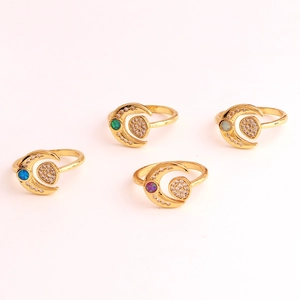 Detailed macro view of four gold-plated moon rings with blue green purple and white stones