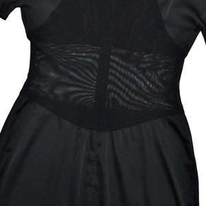Close-up of black sheer mesh patchwork design on the waist of a stylish midi dress