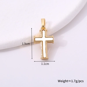 Macro view of gold cross pendant with white inlay showing dimensions 1.9cm by 1.1cm