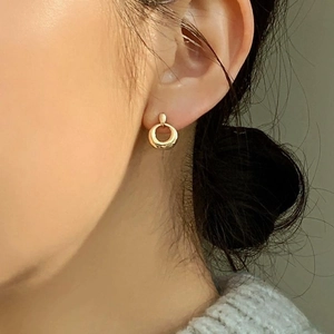 Minimalist 925 sterling silver hollow round stud earrings shown on model side profile