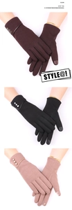 Detail of warm winter gloves for women featuring touch screen fingertips and button decor
