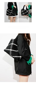 Detailed close-up showing the premium black and white woven texture of the tote bag