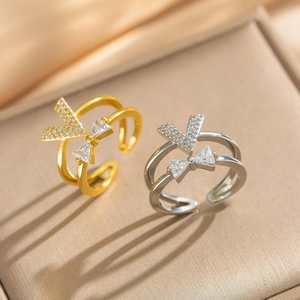 Macro detail of V-shaped adjustable double-layer rings with cubic zirconia on satin