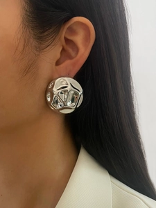 Detailed view of silver hollow semi-circle earrings with hammered metal texture for women