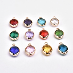 Set of 12 colorful teardrop crystal pendants with gold edges on white background