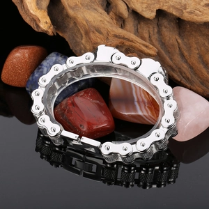 Macro view of silver stainless steel mechanical chain link bracelet with rugged clasp
