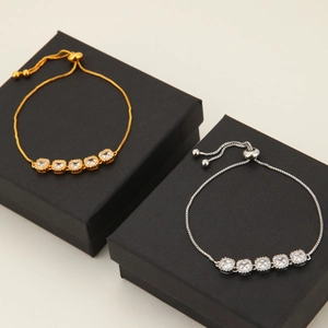 Detail of adjustable moon bracelets featuring five square-cut zircons in gold and silver