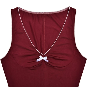 Close-up of deep V-neckline with delicate white lace trim and bow on wine red dress