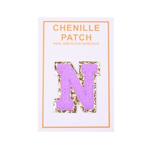Macro view of purple chenille letter N patch with gold sequins and adhesive backing