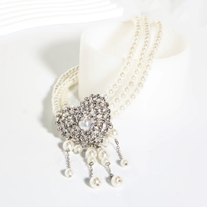 Three-layer pearl necklace with a sparkling heart diamond pendant and elegant tassels