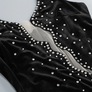 Detail of black velvet evening dress with rhinestone pearls and mesh insert