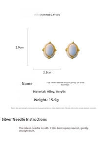 Detail view of vintage oval earrings with white acrylic oil and gold alloy finish