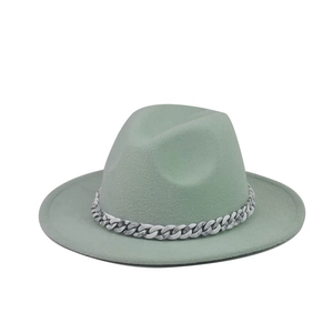 Detail of light green wide brim fedora hat with marble pattern chain decoration