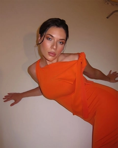 Detail of bright orange one-shoulder dress with elegant tie-up neck and slim fit silhouette