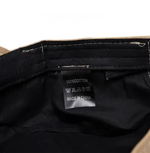 Detailed close-up of 100% cotton wash care label and fabric texture on a flat top cap