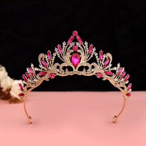 Detail showing the intricate gold frame and pink teardrop crystals on the baroque tiara
