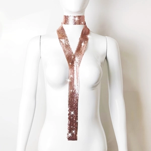 Detail of a sparkling rose gold sequin mesh necktie necklace on a fashion model
