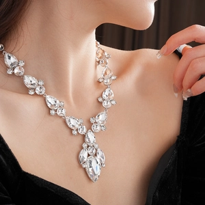 Primo piano di un'elegante collana a goccia d'argento con cristalli scintillanti su modella