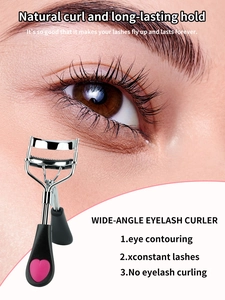 Macro detail of wide-angle eyelash curler with pink heart handle and lash comb