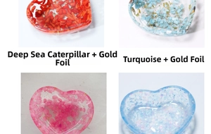 Heart-shaped resin trays featuring turquoise, seashells, gold foil, and colorful crystals