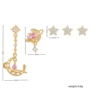 Detailed view of pink zircon earrings set with moon star and planet designs