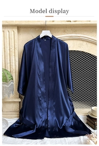 Detailed texture of high-quality dark blue satin silk bathrobe with waist belt
