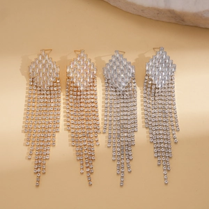 Detailed view of silver and gold tassel earrings with rhinestone diamond fringe