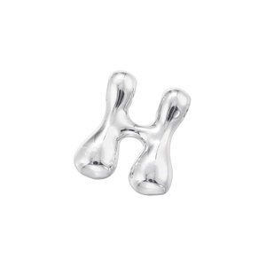 Macro detail of polished silver letter H pendant with liquid metal aesthetic flow