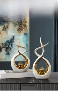 Close-up of modern ceramic art decor with gold plating on dark marble surface