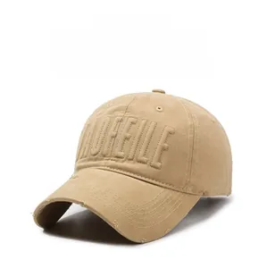 Close-up of khaki baseball cap featuring vintage embroidery and distressed brim details