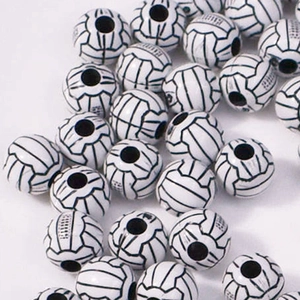 Macro shot of white acrylic volleyball spacer beads with black texture for DIY crafting