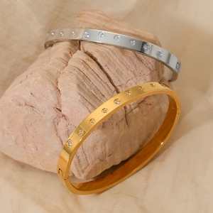 Polished stainless steel bangle set with micro-inlaid crystals in gold and silver finish