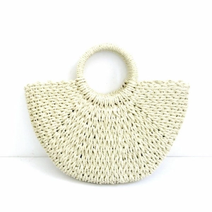 Close-up detail of cream paper rope straw bag with woven texture and round handle