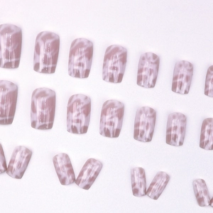 Pink marble press-on nails with white abstract patterns in a square-oval shape