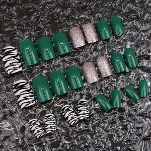 Zebra pattern and green press-on nails set in short square shape with glitter accents