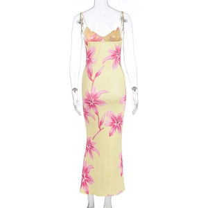Detail of light yellow satin dress featuring pink lily floral prints and slim fit design