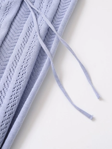 Close-up of lavender blue knit polo set with delicate hollow out texture and drawstring