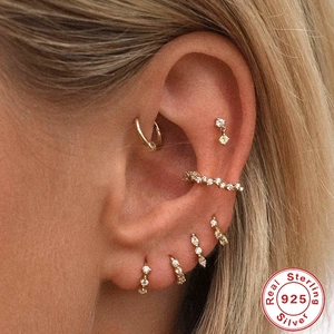 Minimalist 925 sterling silver gold earring set featuring hoops and CZ studs on ear