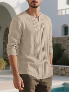 Close-up of beige linen shirt featuring pleated front texture and a small Henley collar